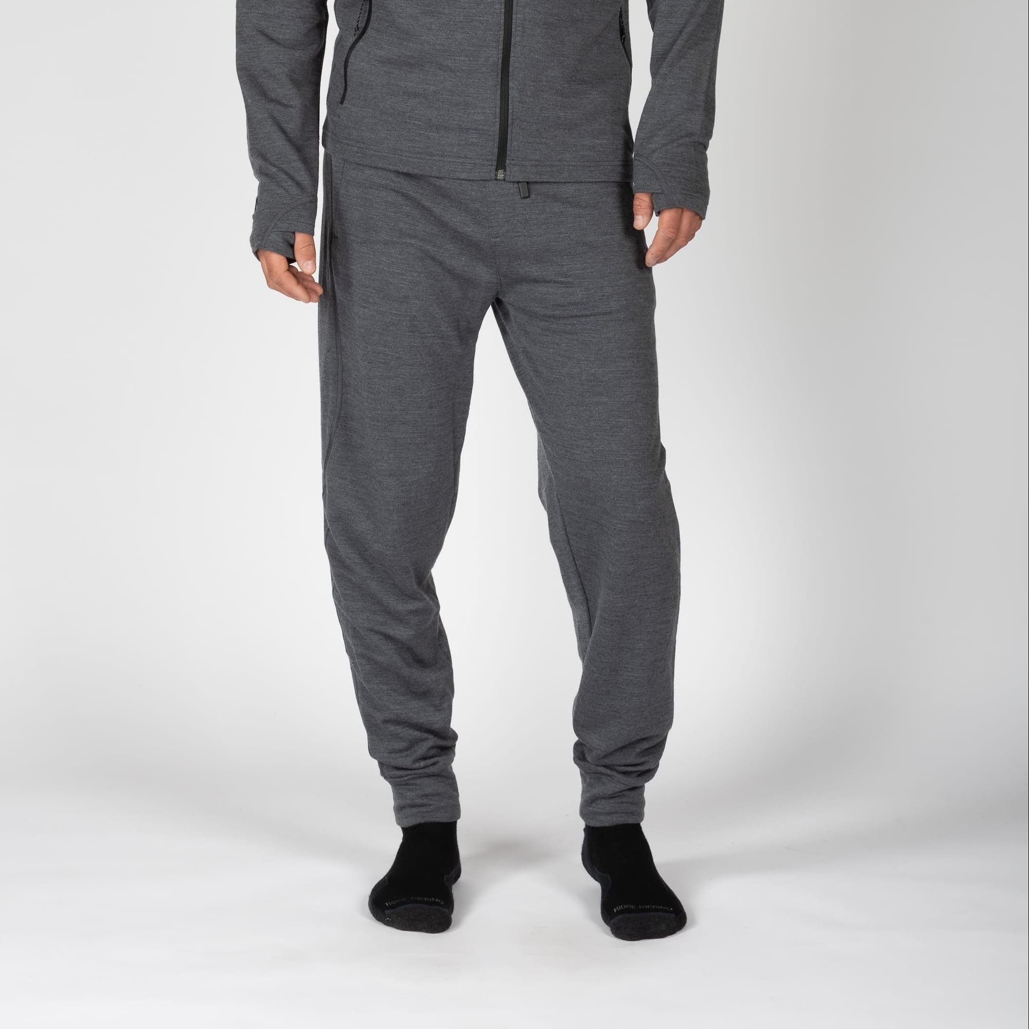 a man wearing gray 100% Merino wool joggers with a matching hoodie