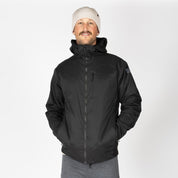 a man wearing a black Alpha Wool Insulated Jacket with a white beanie