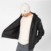 a man wearing a black Alpha Wool Insulated Jacket with a white beanie and white t-shirt underneath