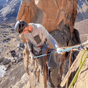 a man rock climbing in a Solstice Pro Sun Hoodie
