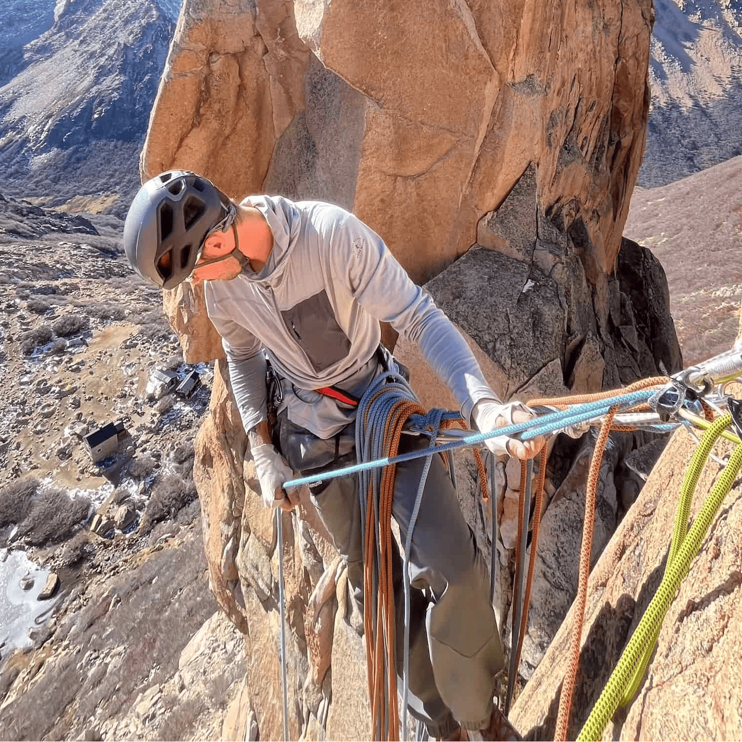 a man rock climbing in a Solstice Pro Sun Hoodie