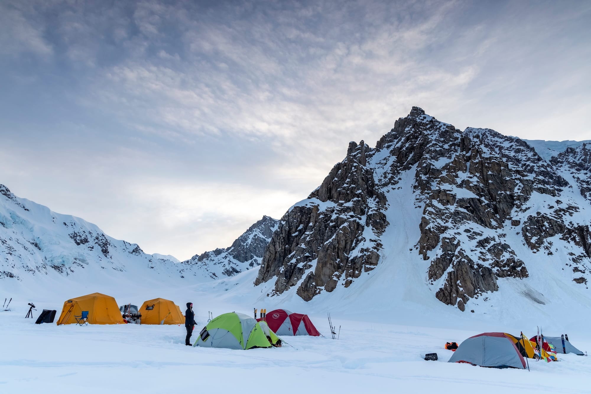 people snow camping on a mountain