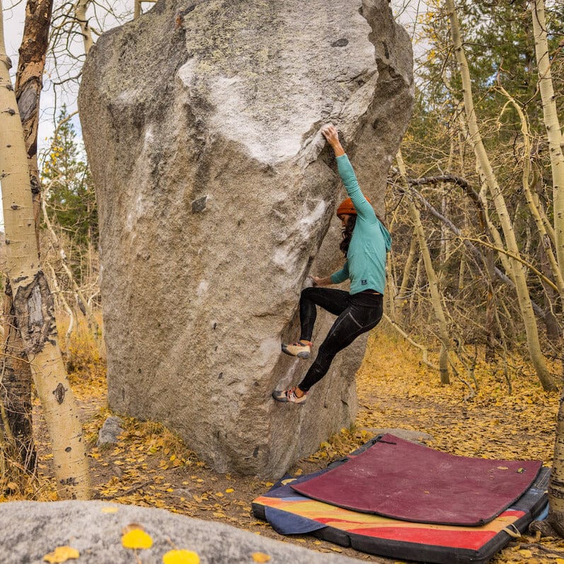 Jenica Law bouldering in Rock Creek Canyon in Crowley Tights and a Convict Canyon Hoodie