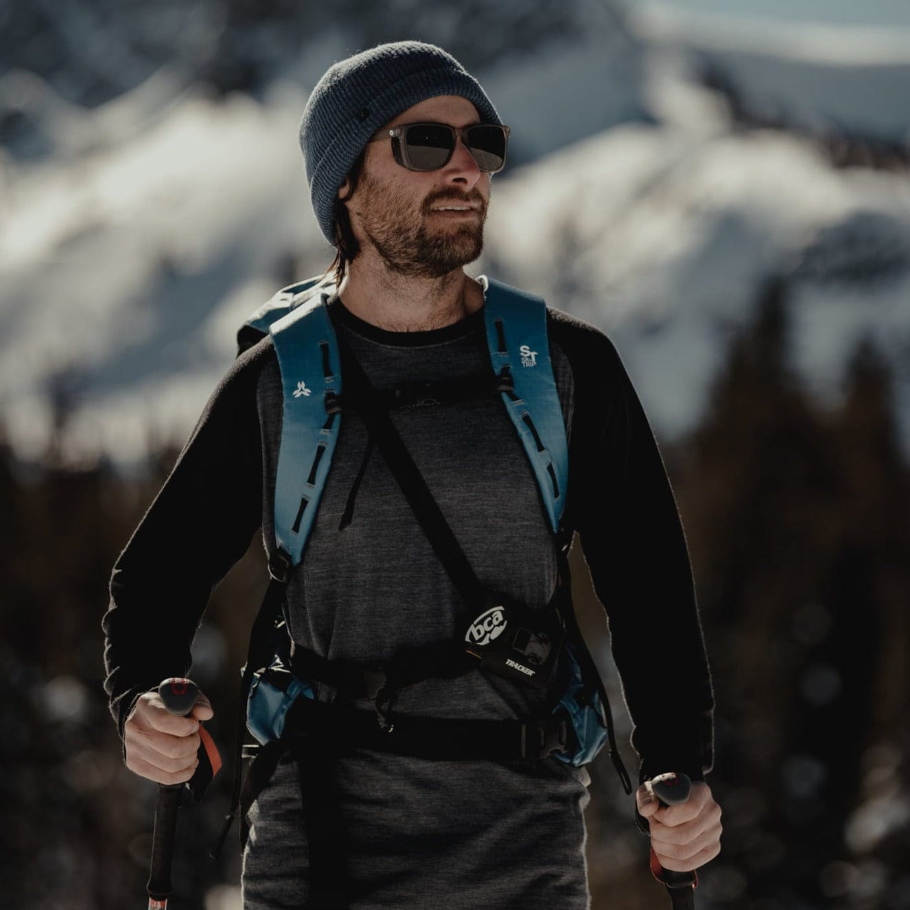 a man splitboarding in an Aspect Base Layer Top