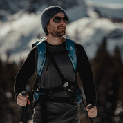 a man splitboarding in an Aspect Base Layer Top