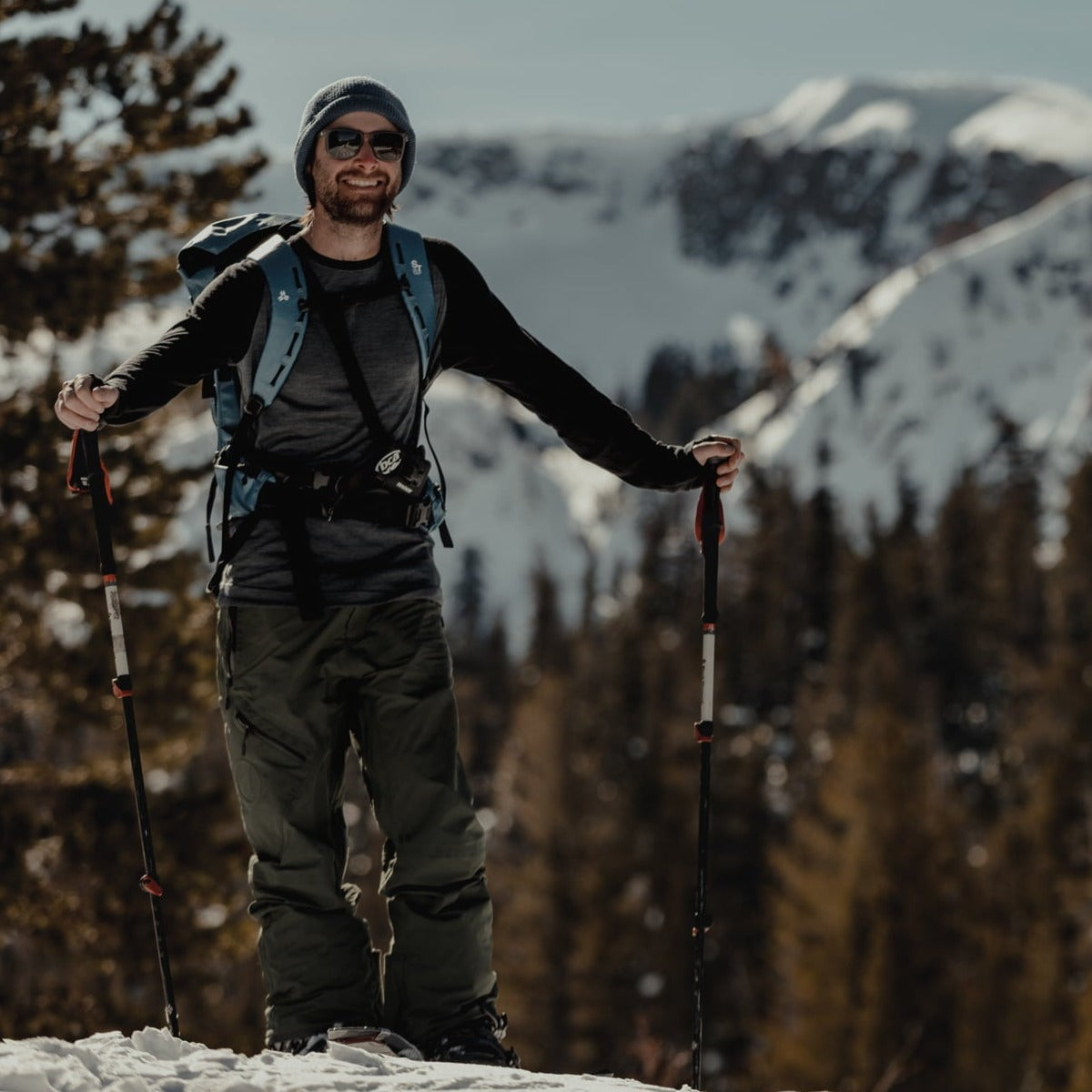a man splitboarding in an Aspect Base Layer Shirt