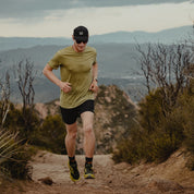 A man trail running wearing the Journey Merino Wool T-Shirt