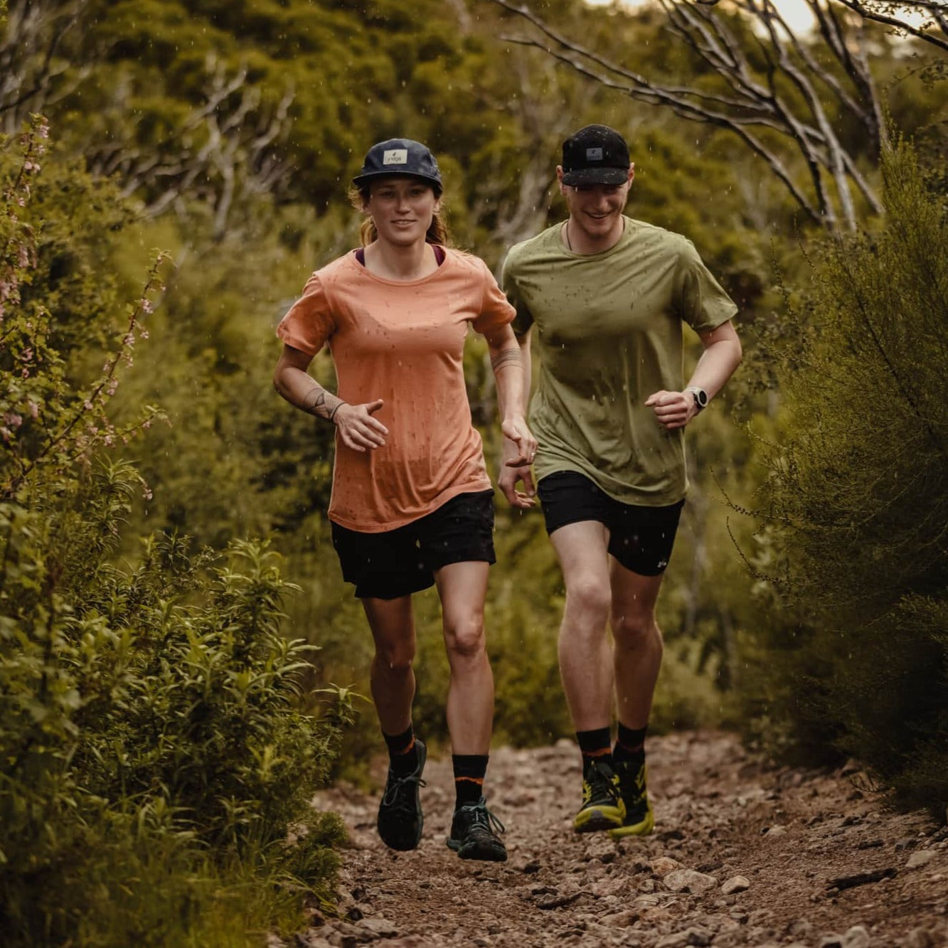 a woman and a man on a trail run in the rain in Malibu