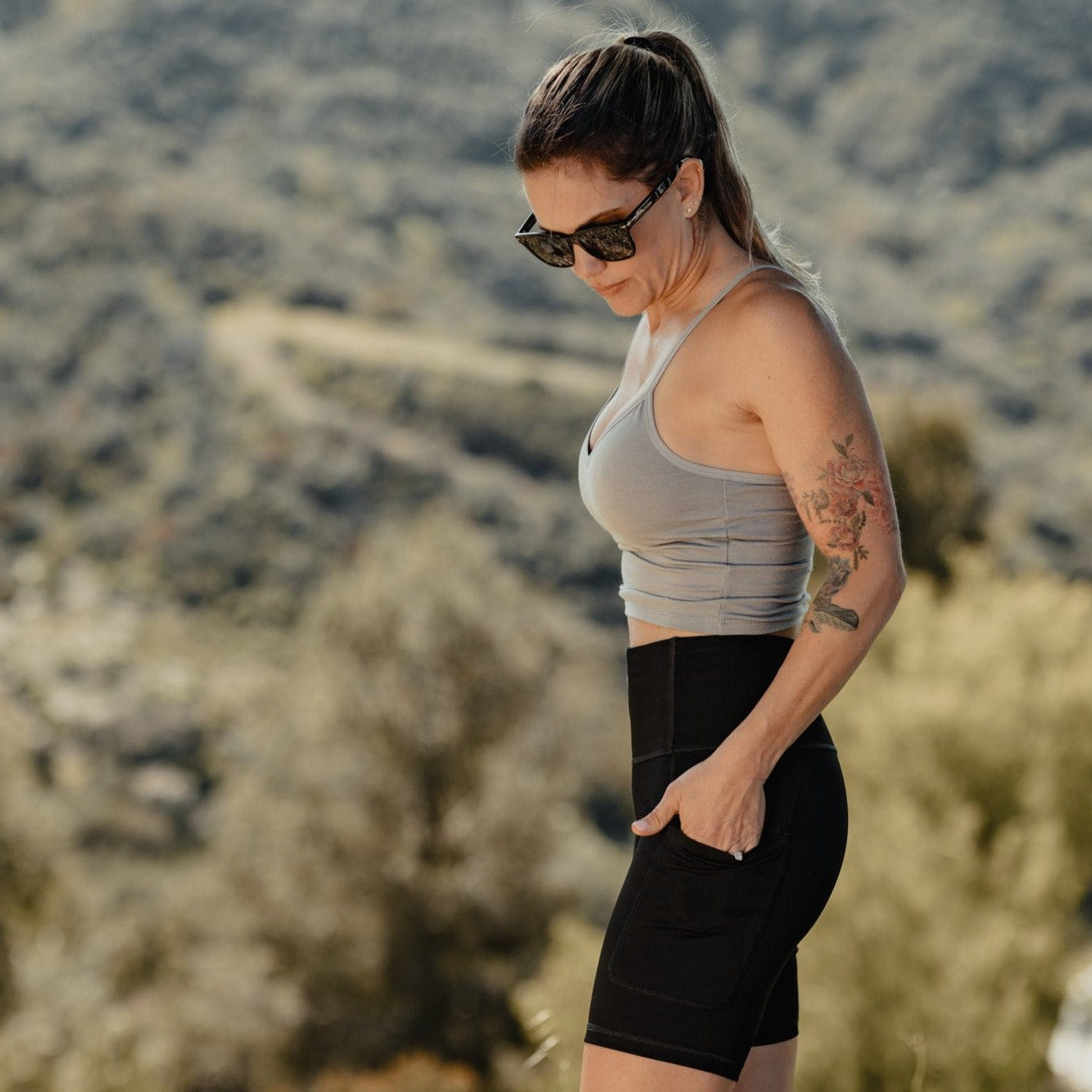 a woman wearing Hilltop Bike Shorts and a Ridge bralette