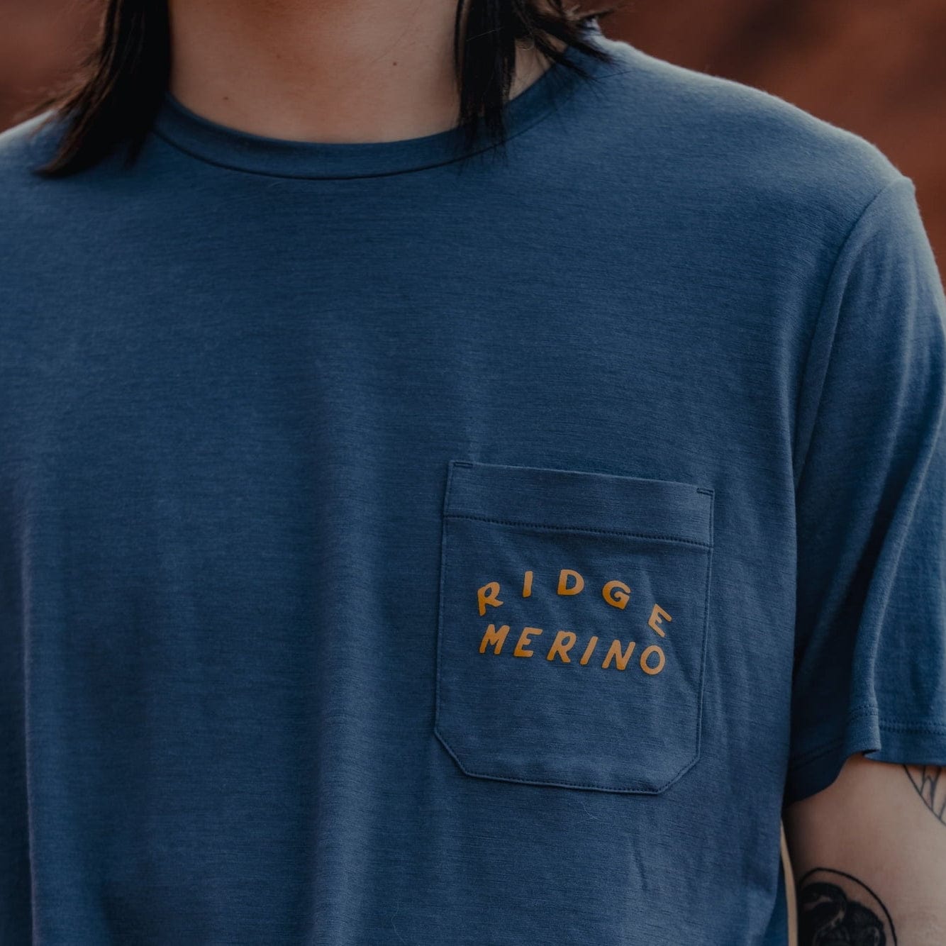 a man wearing a Ridge Merino graphic Journey Pocket Tee