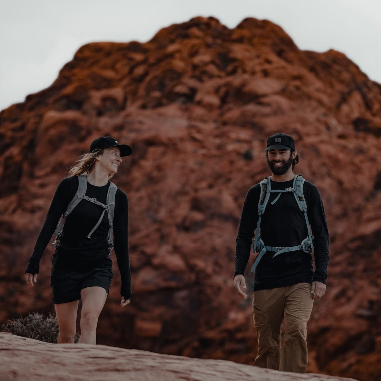 a man and a woman hiking in Aspect Base Layer Shirts