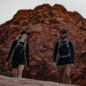 a man and a woman hiking in Aspect Base Layer Shirts