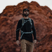 a man hiking in an Aspect Base Layer Shirt