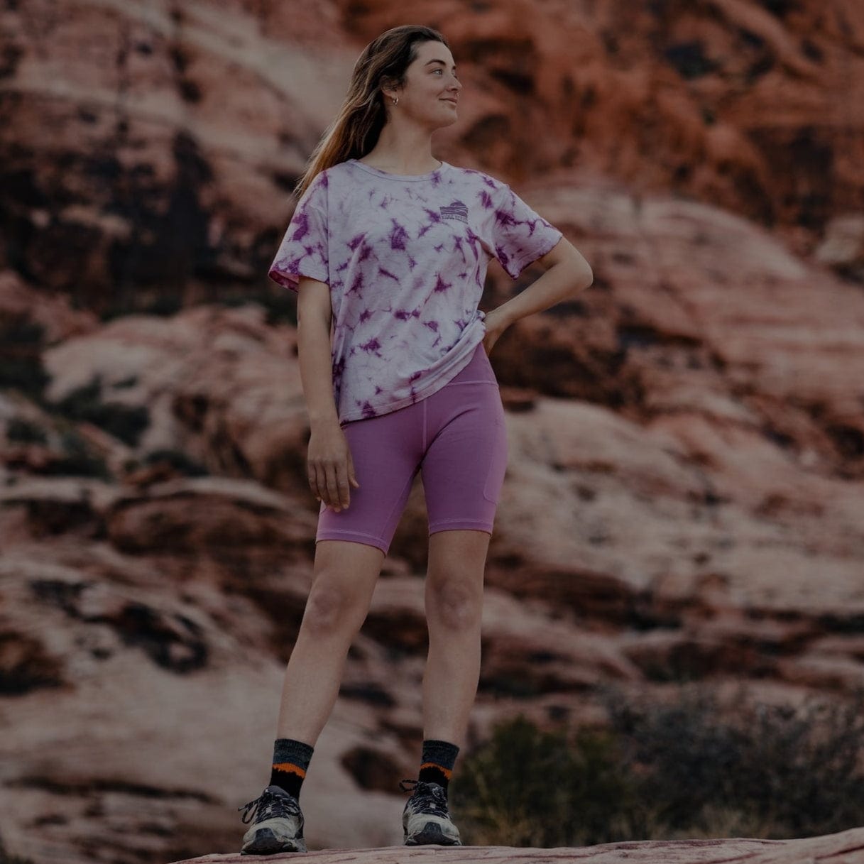 a woman wearing Ridge Merino Hilltop Bike Shorts and a Wander Tie-Dye T-shirt