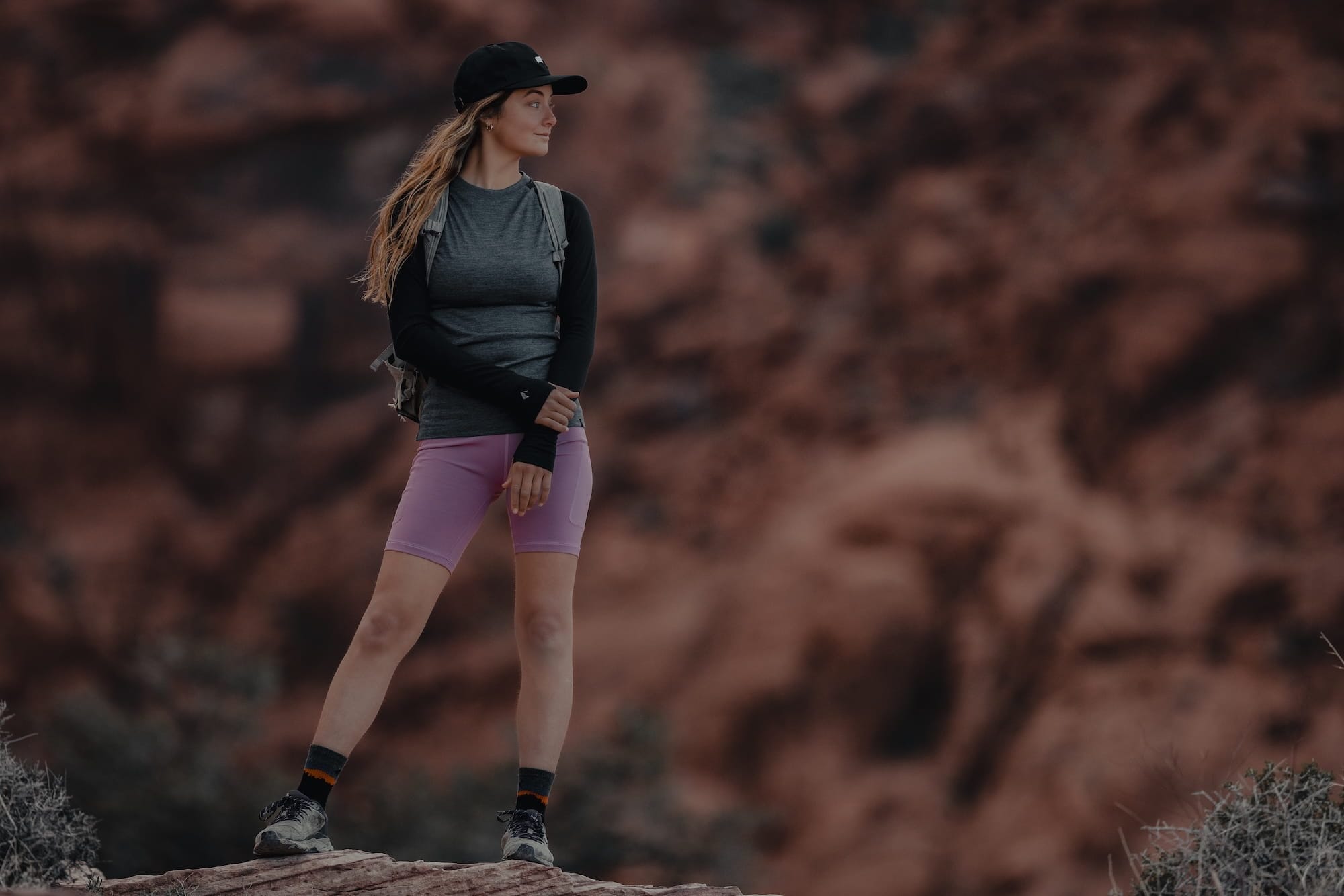 a woman hiking in an Aspect Merino Base Layer Shirt and Hilltop Shorts