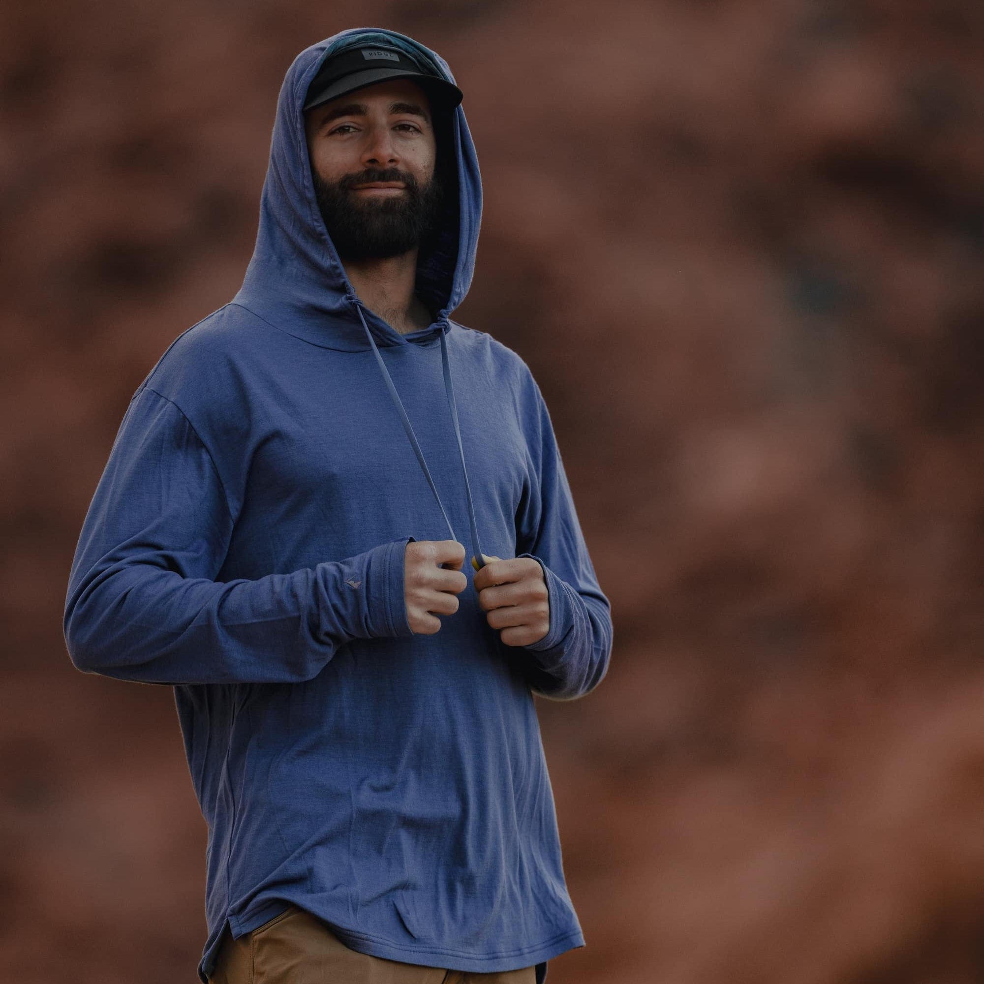 a man wearing a blue Ridge Solstice Sun Hoodie