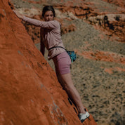 a woman bouldering in Wild Rose Hilltop Bike Shorts