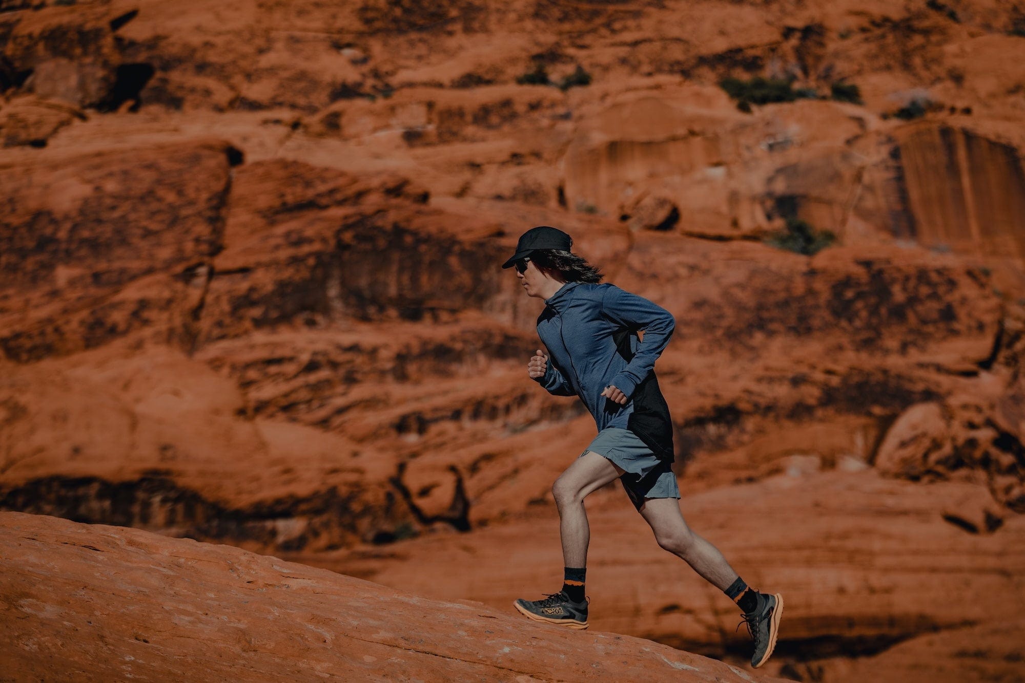 a man running in a Pursuit Ultralight Air Hoodie