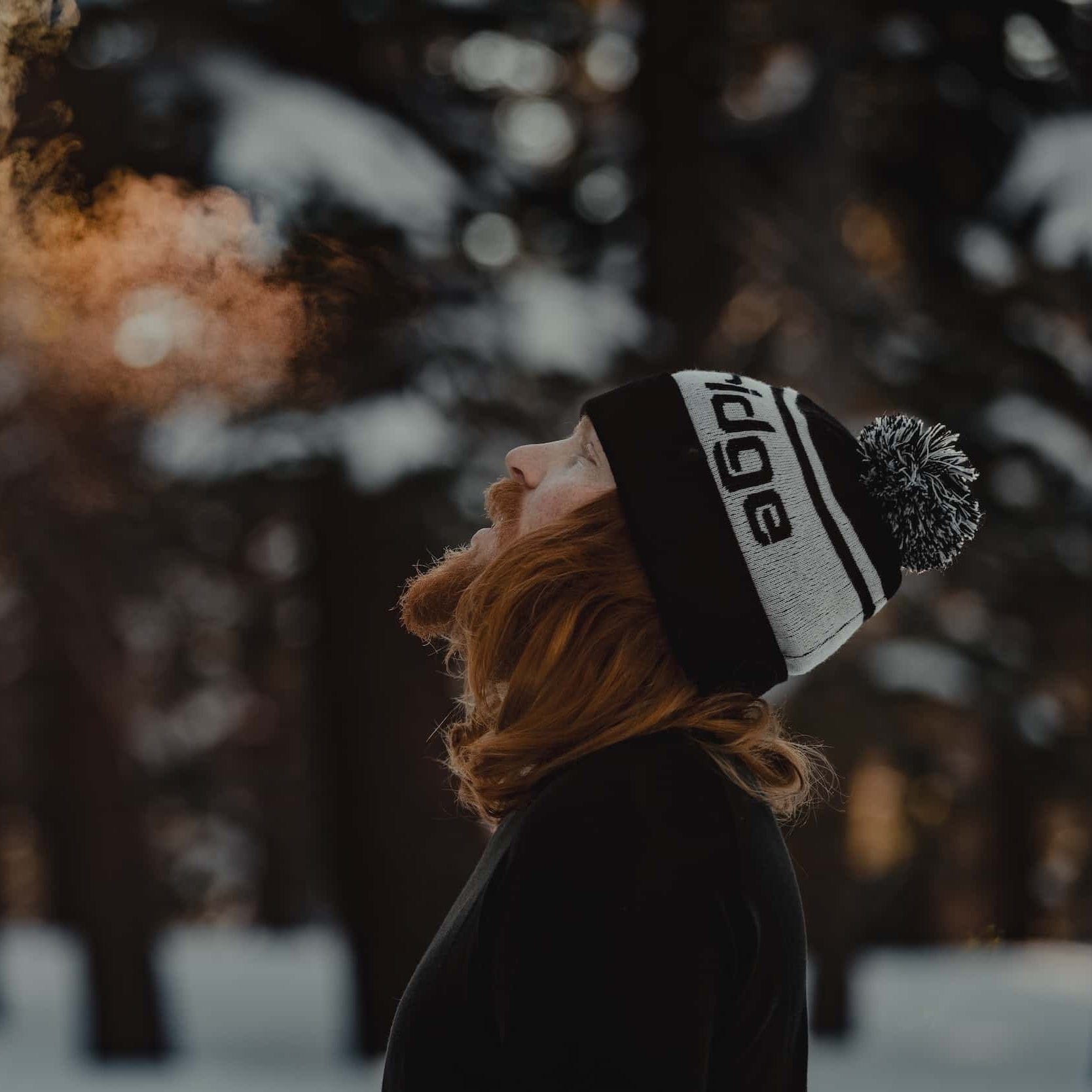 a man wearing base layers and a Ridge Team Beanie on a cold snowy day