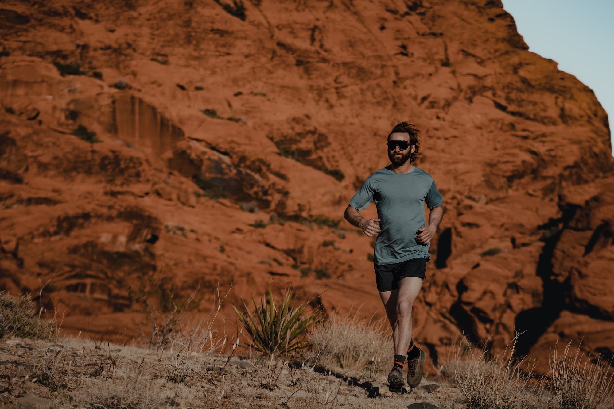 a man running in a Pursuit Merino Ultralight T-shirt