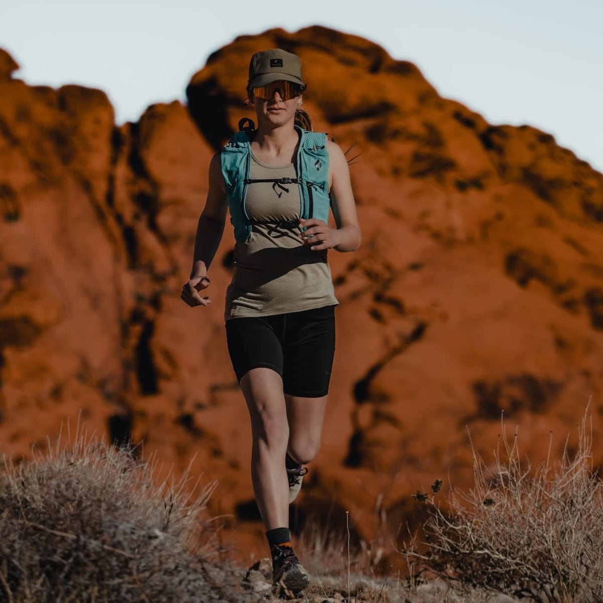 a woman running in a Wander Tank and Hilltop Shorts