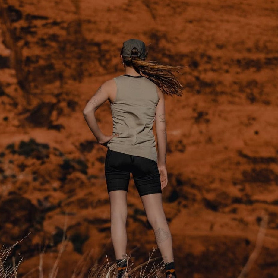 a woman on a hike in a Wander Tank and Hilltop Bike Shorts