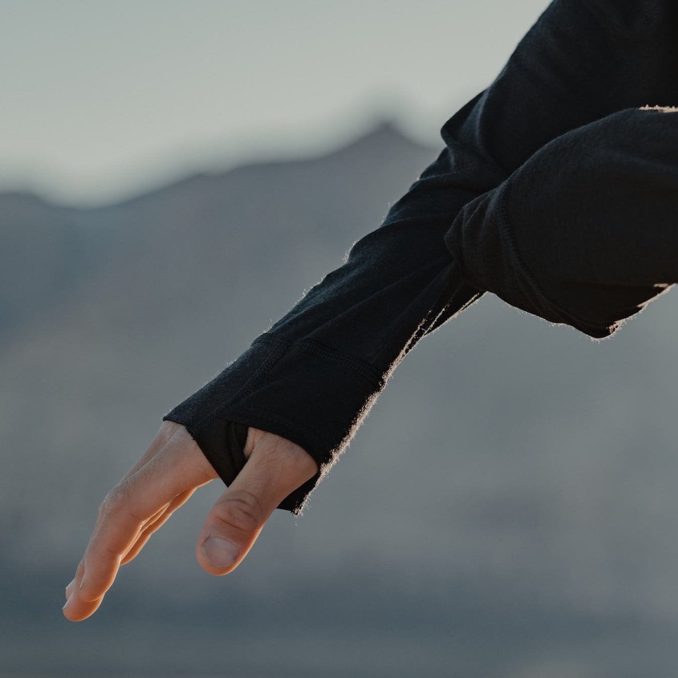 a detail shot of the thumb holes on the Pursuit Pro Merino Hoodie