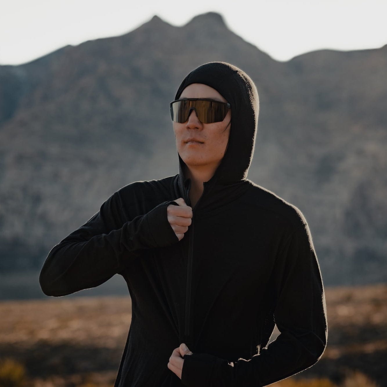 a man wearing a black Pursuit Pro Hoodie