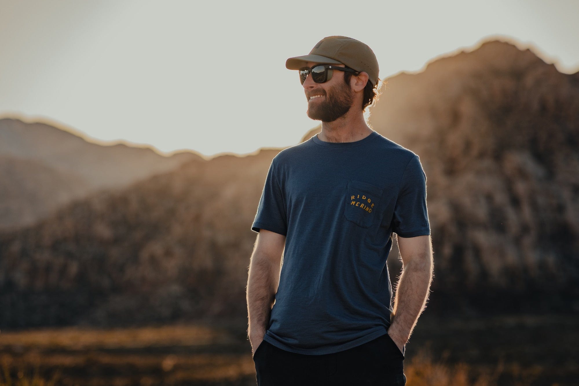 a man wearing a Journey Pocket Tee with the Ridge Merino logo on the pocket