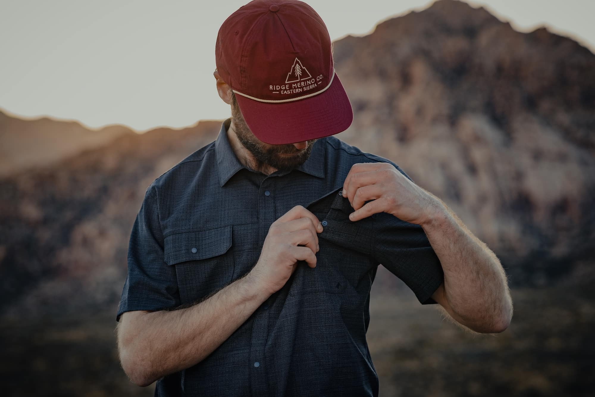 a man wearing an Eastside Hat and High Country Button Down Short Sleeve Shirt