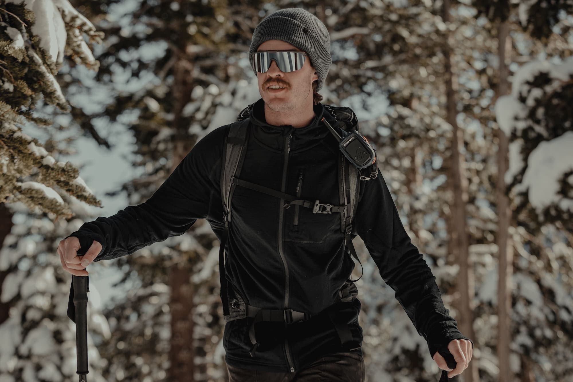 a man ski touring in a black Hyde Merino Wool Hoodie