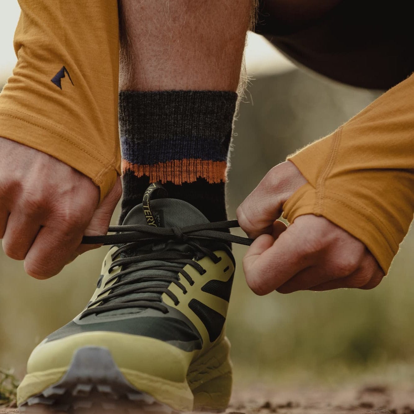 Close up of Ridge Merino socks and the Solstice Hoodie's thumb holes