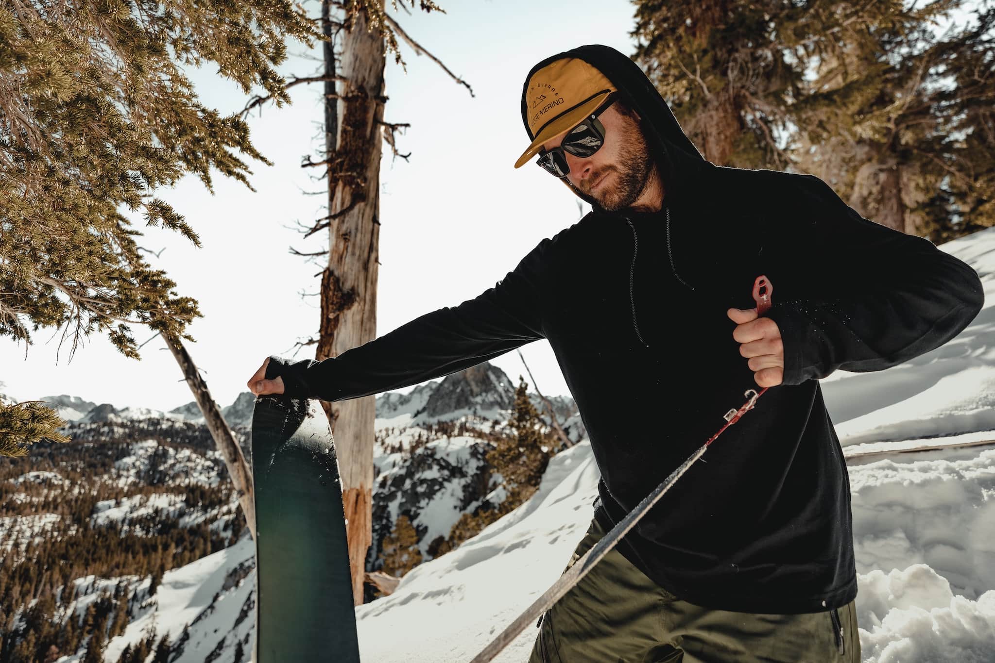 a splitboarder removes skins before descending in the Mammoth Lakes backcountry