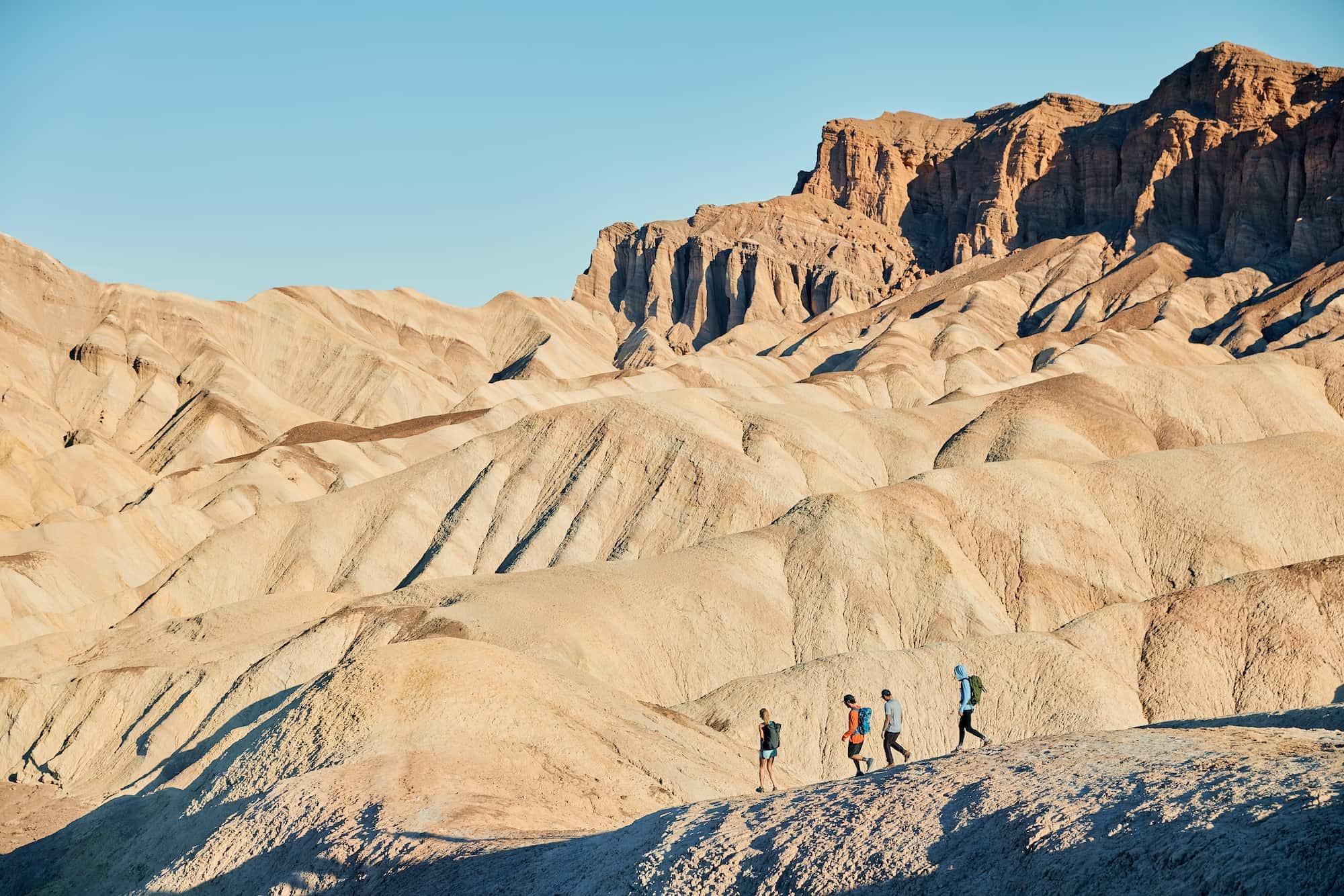 four friends on a sunny hike in the desert