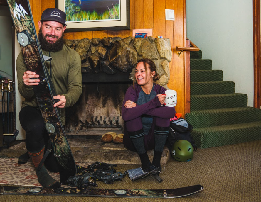 friends drink coffee in Ridge Merino base layers while preparing for a day splitboarding