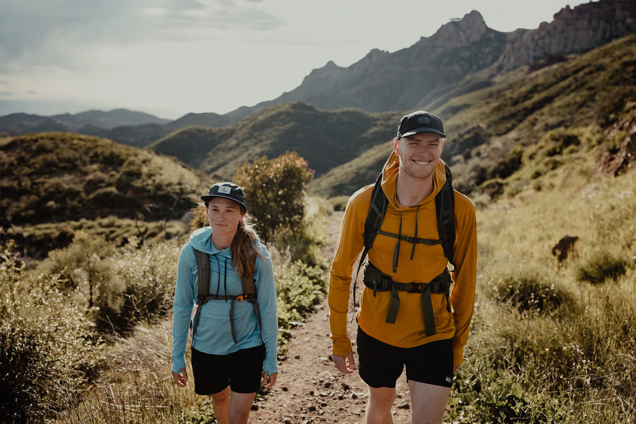 a couple wearing Ridge Merino sun hoodies goes on a hike in Southern California