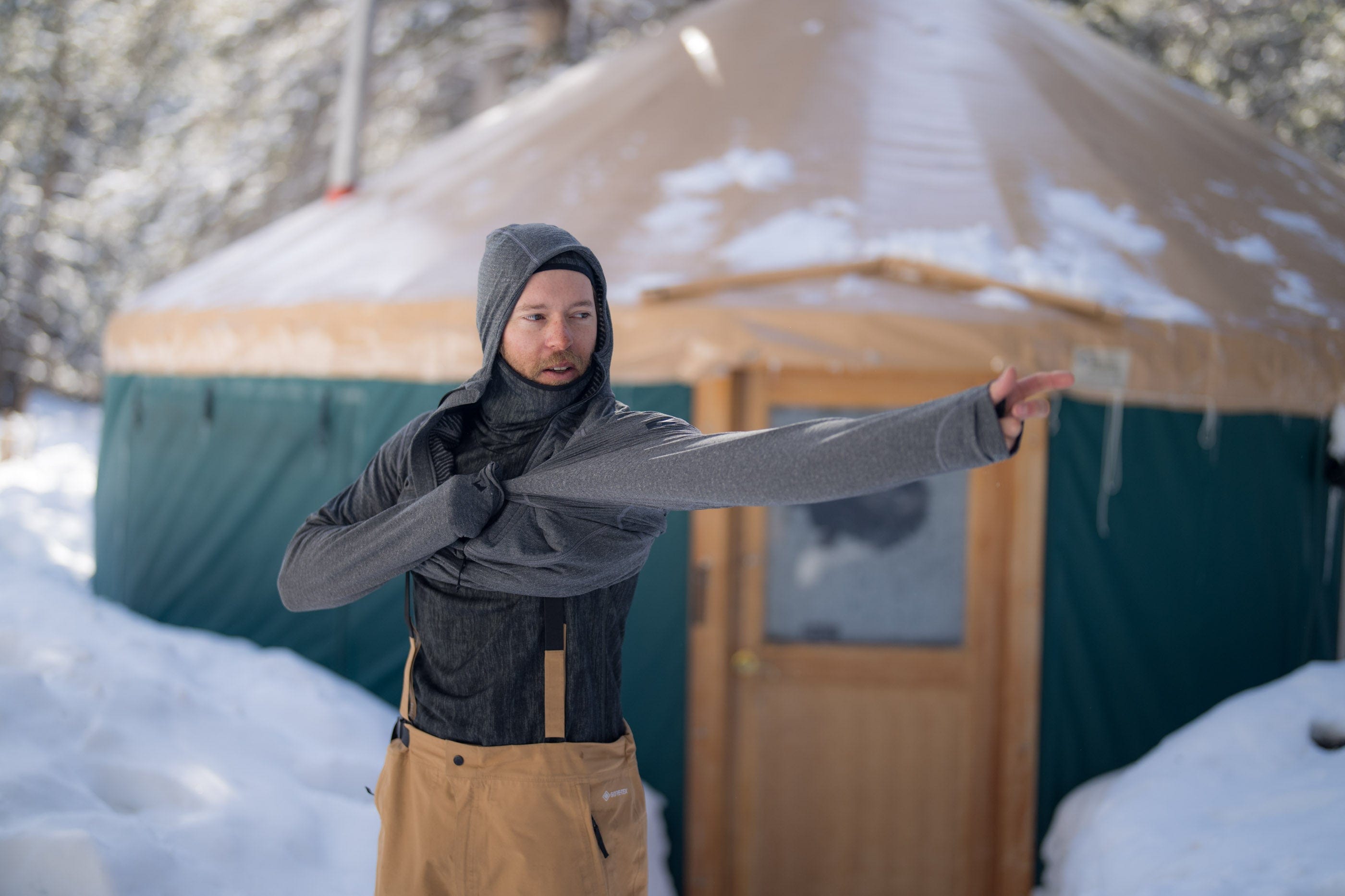 Tim Humphreys layers up at a yurt before a backcountry ski day
