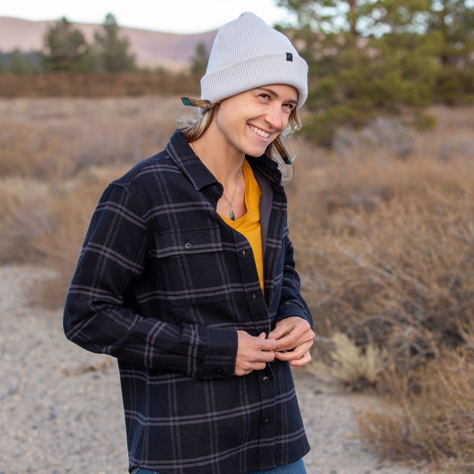a woman wearing a Treeline Merino Flannel and Ridge Beanie