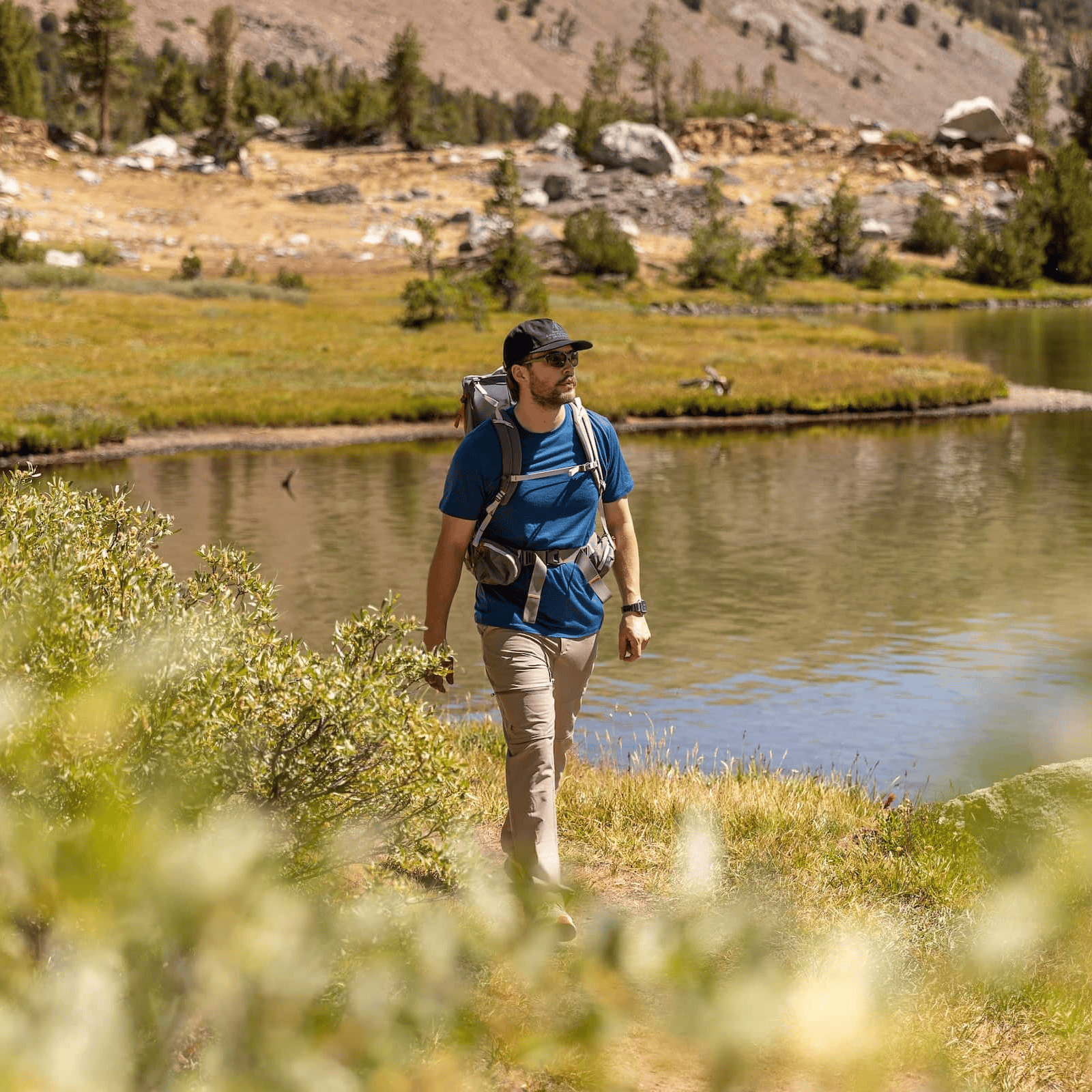 a man backpacking wearing a Journey Merino Wool T-Shirt in Sailor Blue