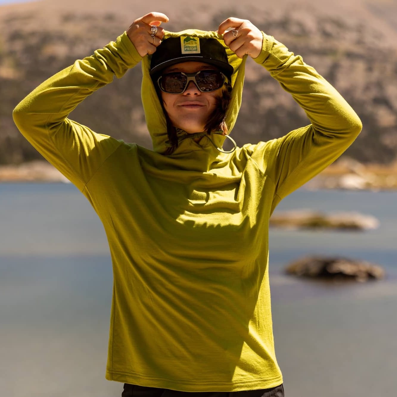 a woman puts the hood up on the Solstice Sun Hoodie