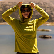 a woman puts the hood up on the Solstice Sun Hoodie