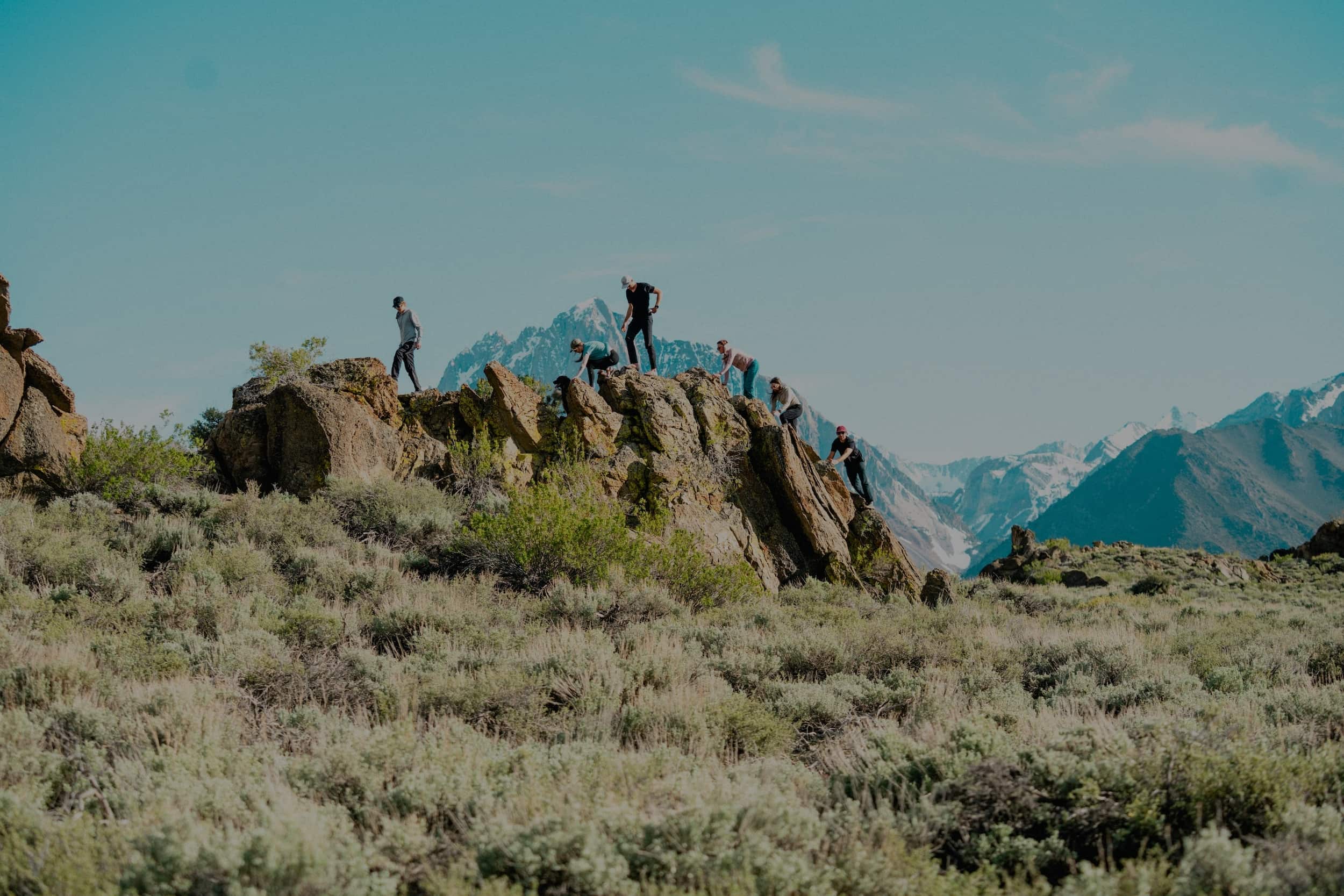 a group of friends walking on a rocky mountain ridge