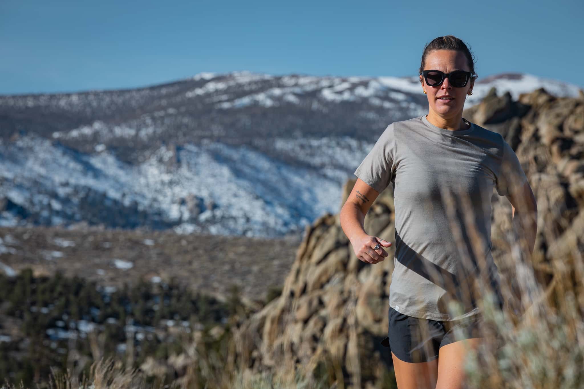 a woman running in a Pursuit Ultralight Tee