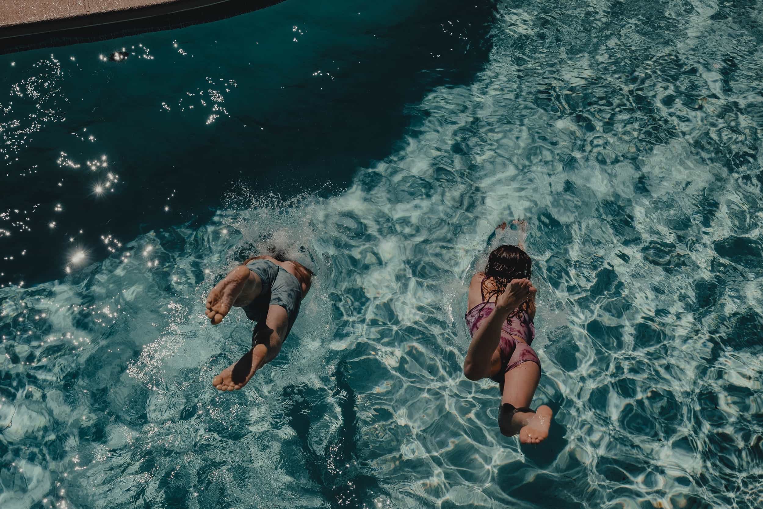 two people dive into a swimming pool in Ridge Merino tie-dye underwear