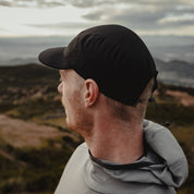 a man wearing the Pursuit Hoodie and Ridge Run Merino Hat