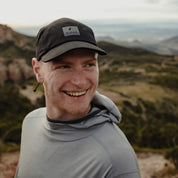 a man wearing the Pursuit Hoodie and Ridge Run Merino Hat