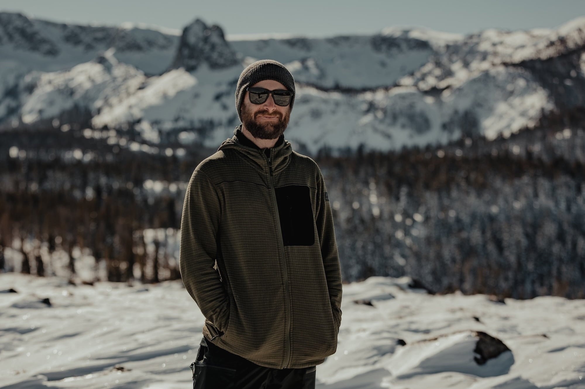a man smiles wearing a Cloudripper Grid Fleece Mid Layer