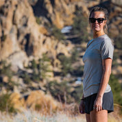 a woman wearing a Pursuit Ultralight Tee on a spring run