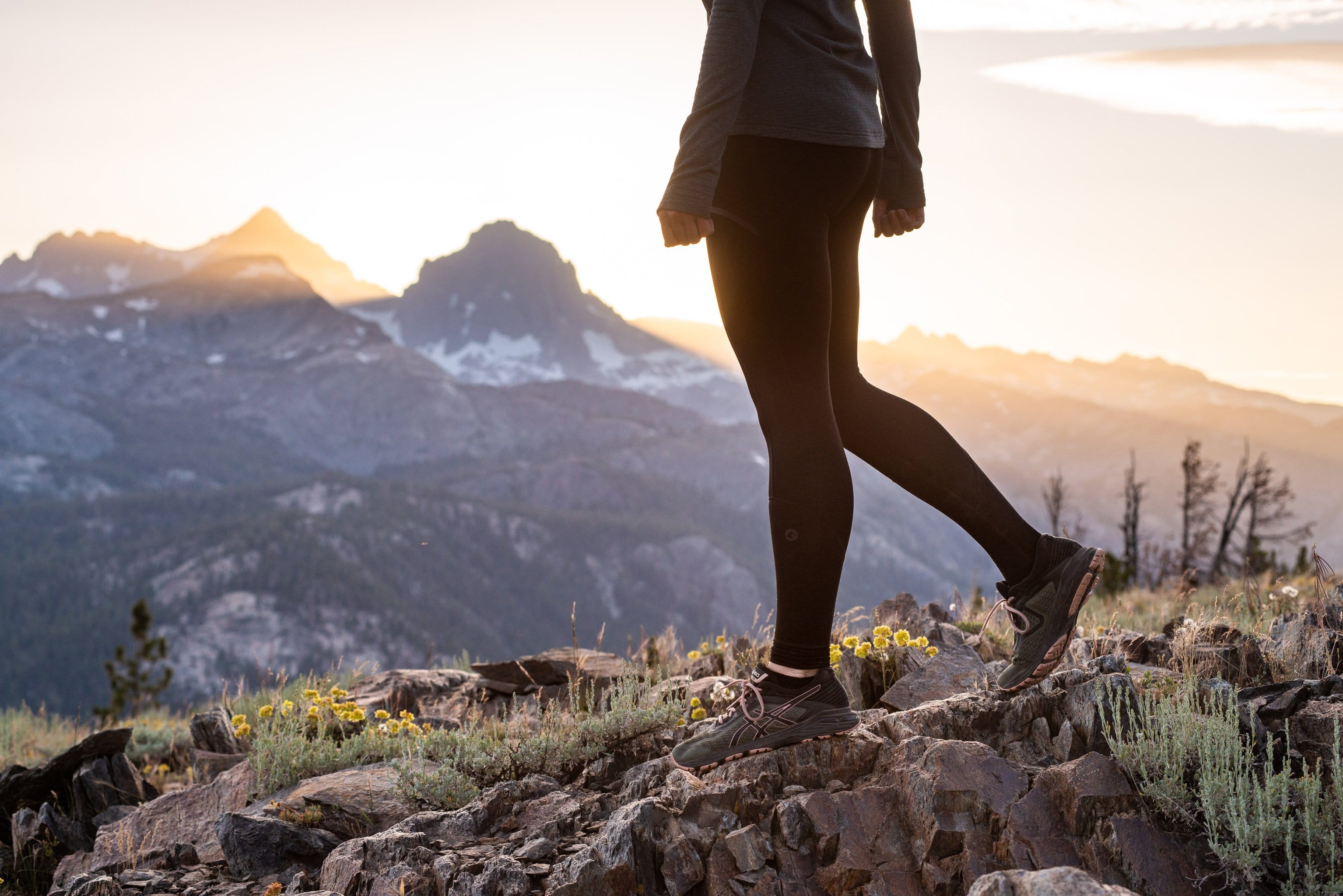 a woman pauses on a trail run in Mammoth Lakes wearing the Ridge Merino Crowley Tight