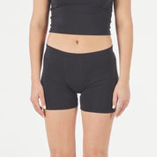 a woman wearing Ridge Merino boy shorts in the longer 5" inseam with a Ridge Merino bralette